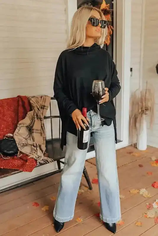 Full outfit view of black cowl neck shift tunic top with wide-leg jeans, perfect for a laid-back seasonal style.