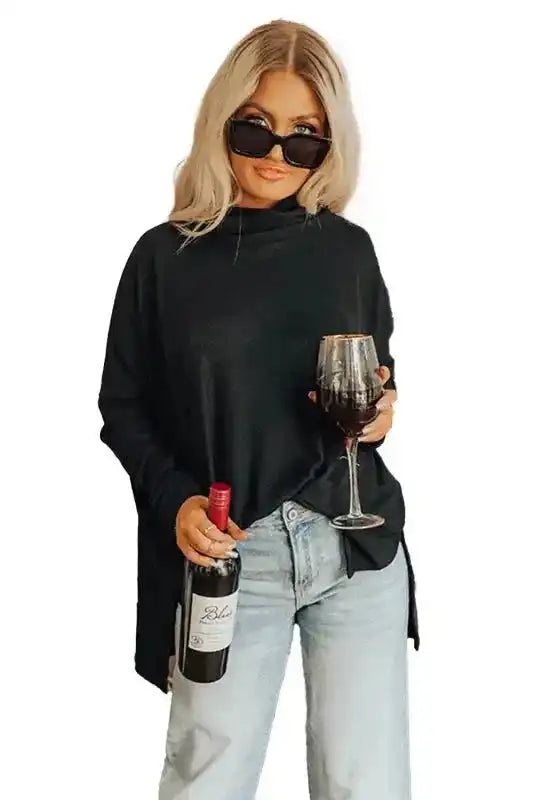 Studio-style image of black cowl neck tunic top with long sleeves, showcasing its relaxed fit and soft fabric.