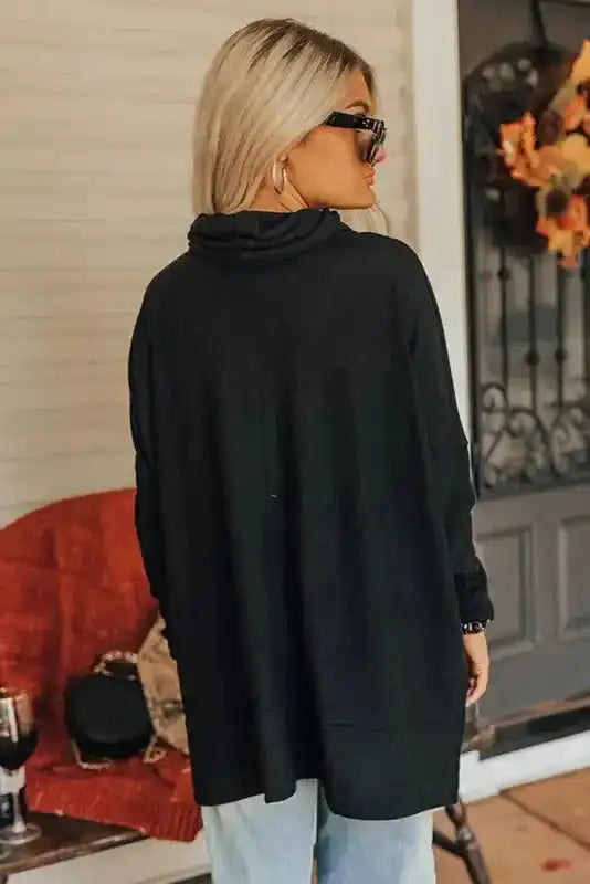 Back view of black cowl neck tunic top showing relaxed fit and lightweight fabric, perfect for casual winter outfits.
