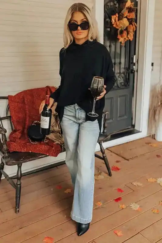 Black cowl neck tunic top styled with denim and boots, ideal for casual winter layering and daily wear.