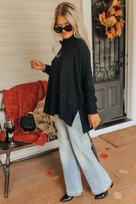 Side profile of black cowl neck shift tunic top highlighting its flowy silhouette and lightweight comfort.