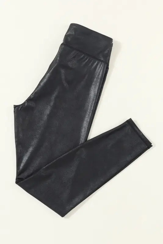 Black crossed dip waist sleek leather leggings