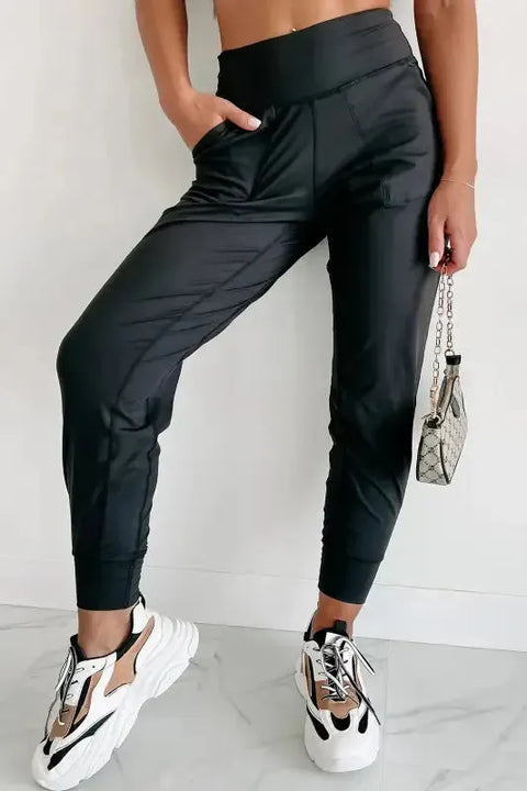 Woman wearing black exposed seam high waist pocketed joggers front view Fashionfitz UK