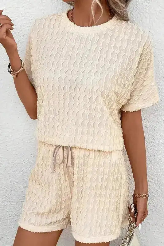 Beige frill textured co-ord set with short sleeve top and drawstring shorts. Lightweight and stylish for summer lounging.