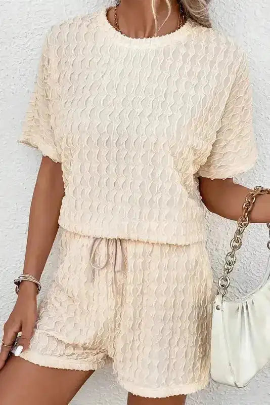 Beige textured co-ord set for women with short sleeve top and shorts. Breathable and chic for summer casual style.
