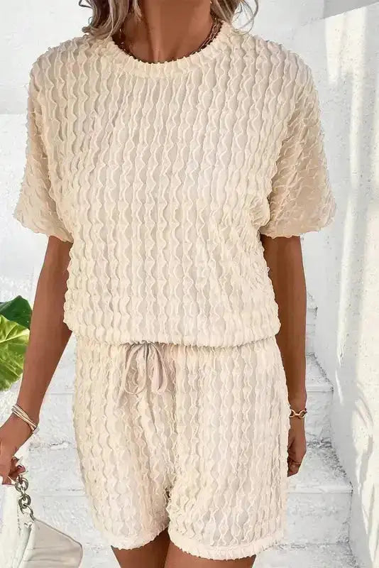 Light beige frill textured two-piece set with short sleeves and elastic waist shorts. Perfect for warm weather loungewear.