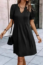 Front view of black Notched Pleat Puff Sleeve Shift T-Shirt Dress featuring soft pleats and flattering V-notch neckline.