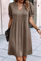 Taupe Notched Pleat Puff Sleeve Shift T-Shirt Dress styled with accessories, showcasing flattering neckline and H-line silhouette.