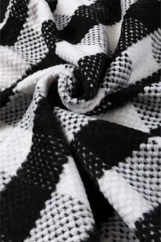 Close-up of black plaid shacket fabric showing soft textured wool blend, ideal for chic winter outfits and modern outerwear layering.