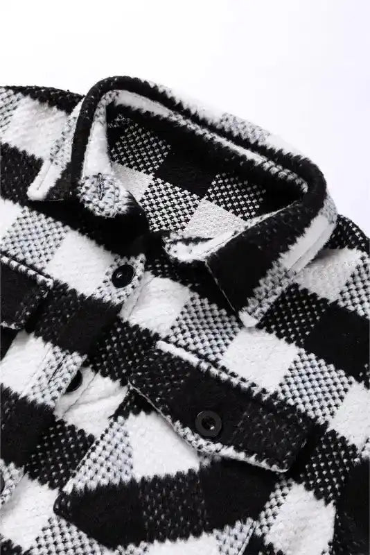 Close-up of collar and buttons on black plaid shacket for winter outfits, highlighting soft texture and quality stitching.