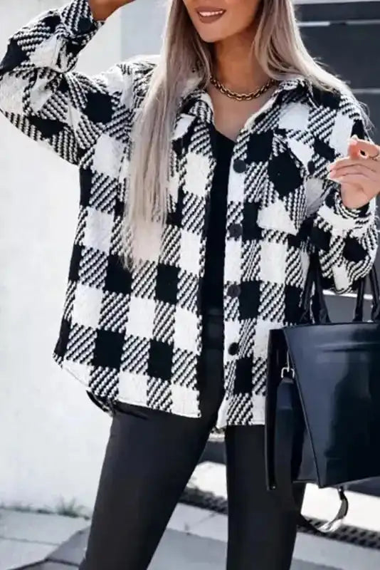 Chic black plaid shacket for winter outfits paired with black top and leather pants, ideal for stylish cold-season layering.