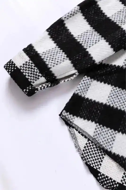 Sleeve detail of black plaid shacket for winter outfits, showcasing cuff button and textured fabric for cold-weather comfort.