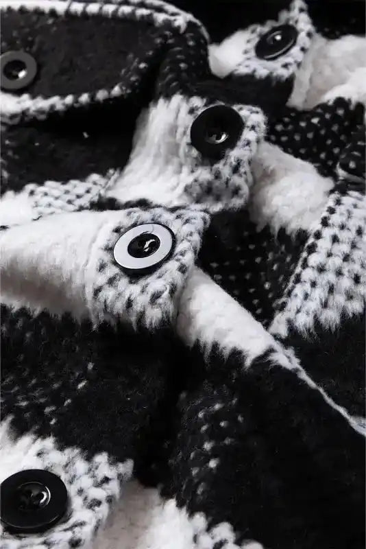 Close-up of button placket on black plaid shacket for winter outfits, emphasizing warm fabric and secure fastening.