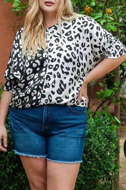 Close-up of plus size blouse featuring bold black and white leopard print and relaxed fit for casual summer outfits.