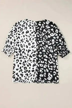 Back flat lay of plus size blouse with contrasting black and white leopard print and smocked half sleeves for summer wear.