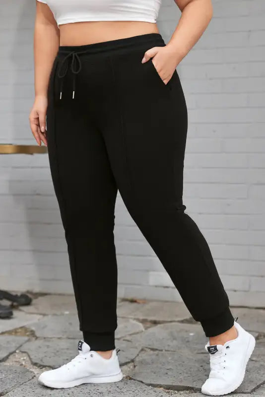 Black plus size textured exposed seam drawstring jogger pants