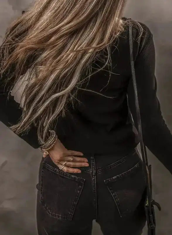 Back view of Black Ribbed V‑Neck Long Sleeve Top showing fitted silhouette and soft stretch fabric for everyday wear.
