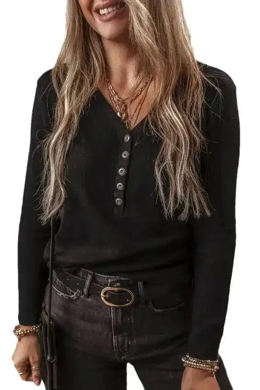 Studio image of Black Ribbed V‑Neck Long Sleeve Top on model, emphasizing its sleek design and everyday versatility.