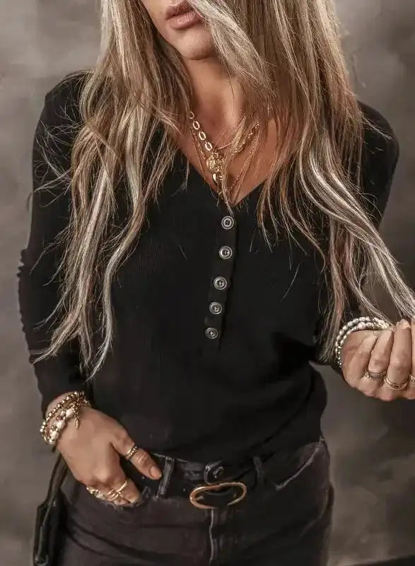 Close-up of Black Ribbed V‑Neck Long Sleeve Top highlighting button detail and ribbed texture, ideal for casual outfits.