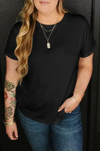 Black plus size round neck T-shirt with rolled sleeves, styled with jeans and layered jewelry for a chic casual look.