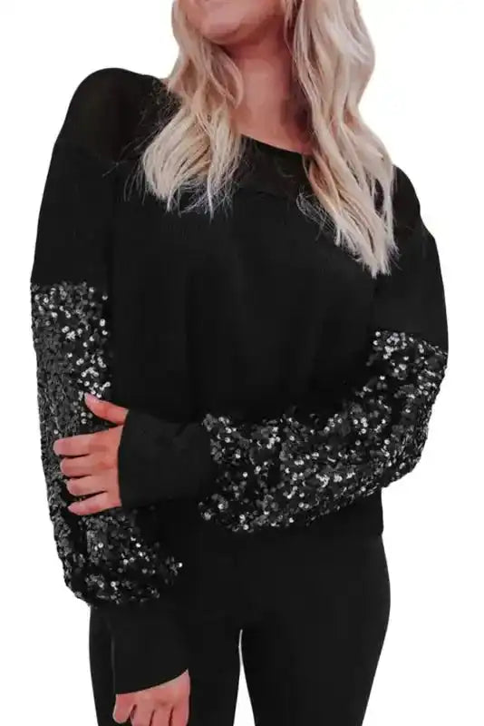 Close-up front angle of Black Sequin Lantern Sleeve Blouse highlighting the sparkle of the sequin patchwork and soft knit fabric.