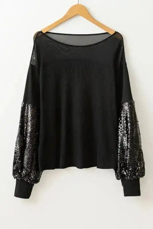 Black Sequin Patchwork Lantern Sleeve Blouse on hanger showing full sleeve detail and sheer neckline, perfect for chic evening wear.