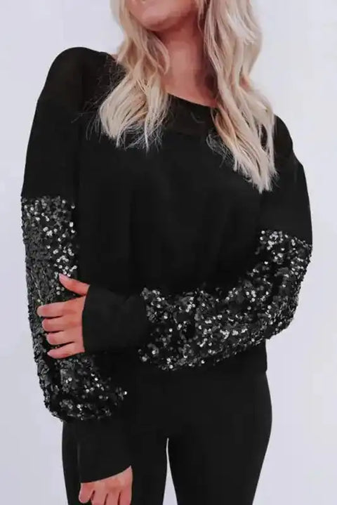 Elegant Black Sequin Lantern Sleeve Blouse with sheer neckline and shimmering patchwork sleeves, ideal for evening wear or fall outings.