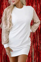 White mini dress with shimmering sequin balloon sleeves, styled for partywear against a red festive backdrop.