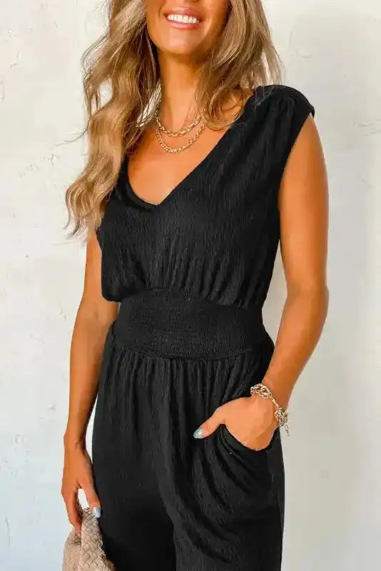 Detail view of Black Shirred Jumpsuit V-Neck showing textured fabric and high waist fit, ideal for summer casual fashion.