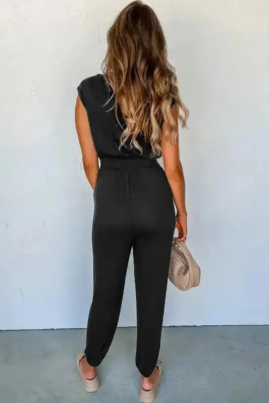 Back view of Black Shirred Jumpsuit V-Neck showing high waist fit and relaxed leg cut, ideal for casual summer wear.