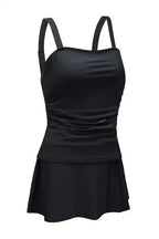 Studio image of black square neck tankini swimsuit with ruched waist and flared skirt, perfect for stylish swimwear.