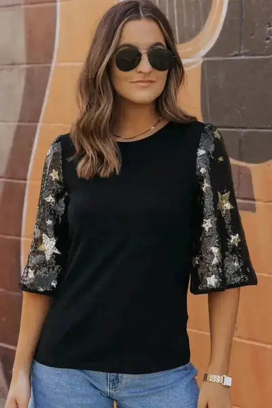 Elegant Black Star Sequin Top with glittery star accents on sleeves, perfect for night outs or festive occasions.