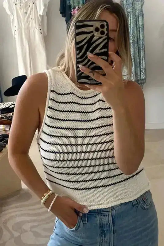 Angled front view of Black Stripe Raw Edge Knitted Vest styled with denim jeans, emphasizing its relaxed fit and stripe detailing.