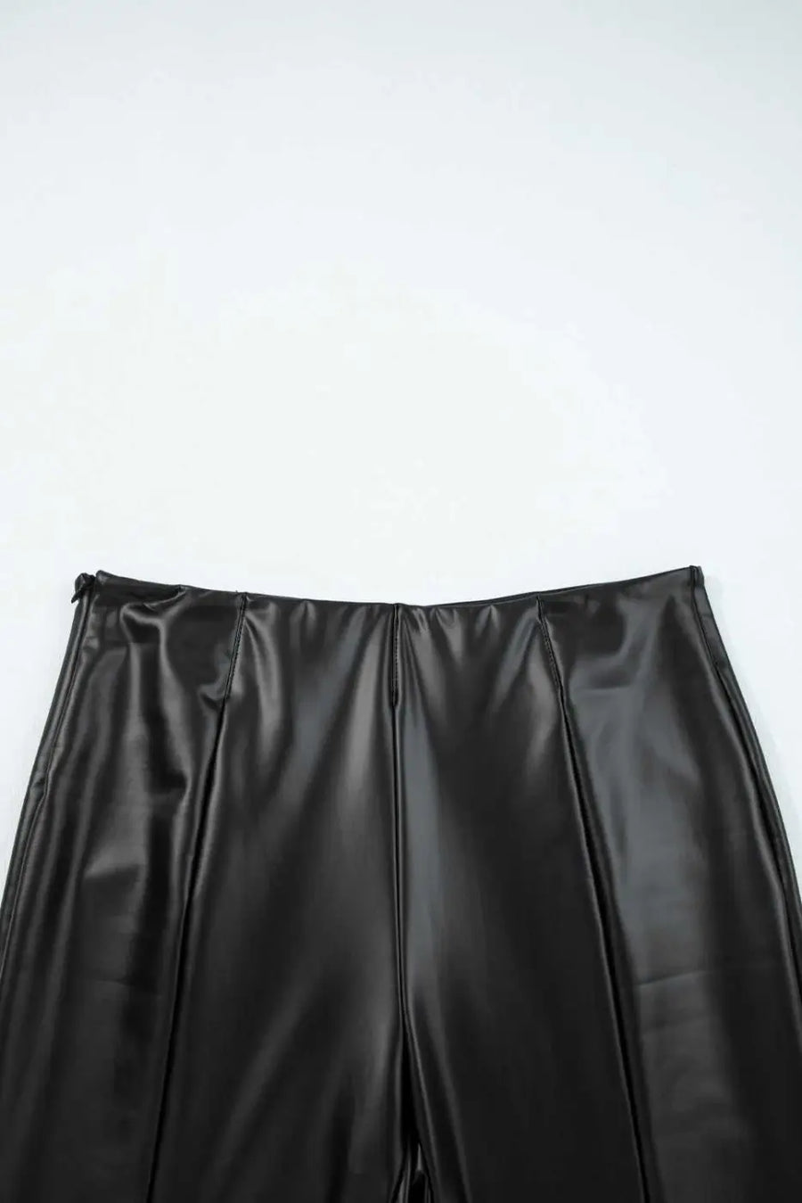 Top waistband detail of Black Vegan Leather Leggings – High‑Rise Skinny Fit showing clean lines and structured high-rise fit.