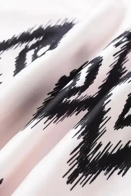 Fabric close-up of the White Aztec Print Western Sundress showing the soft texture and sharp black Aztec motifs.