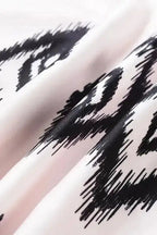 Fabric close-up of the White Aztec Print Western Sundress showing the soft texture and sharp black Aztec motifs.