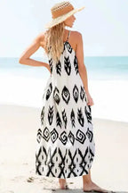 Back view of the White Aztec Print Western Sundress worn on the beach, showcasing its flowy silhouette and summer-ready style.