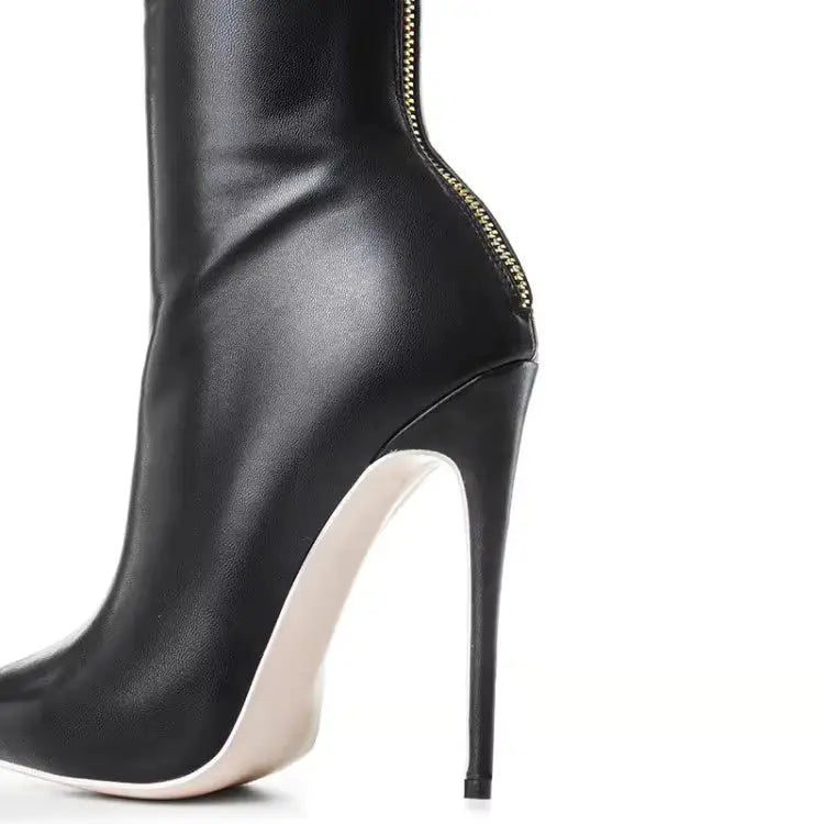Close-up of black over knee boot heel with gold back zipper and 11cm stiletto. Elegant and functional design for women’s fashion boots.