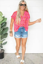 Wild in Pink Leopard Blouse paired with denim shorts and sandals. V-neck short sleeve top perfect for casual summer and western-inspired outfits.