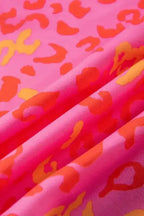 Fabric detail of Wild in Pink Leopard Blouse showing soft texture and vivid pink, orange, and yellow leopard print. Ideal for casual summer wear.