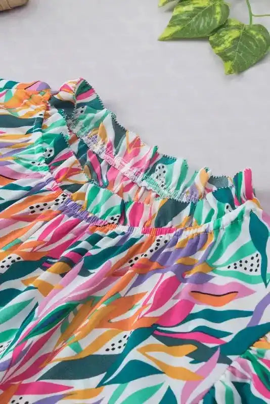 Close-up of neckline on Pink Floral Flutter Sleeve Blouse showing elastic ruffle collar and vibrant summer-ready print.