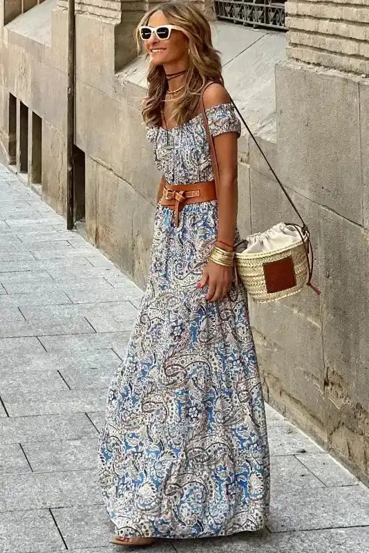 Side view of Blue Boho Paisley Maxi Dress - Off Shoulder Bardot from FashionFitz, featuring flowing viscose fabric and summer-ready paisley print.