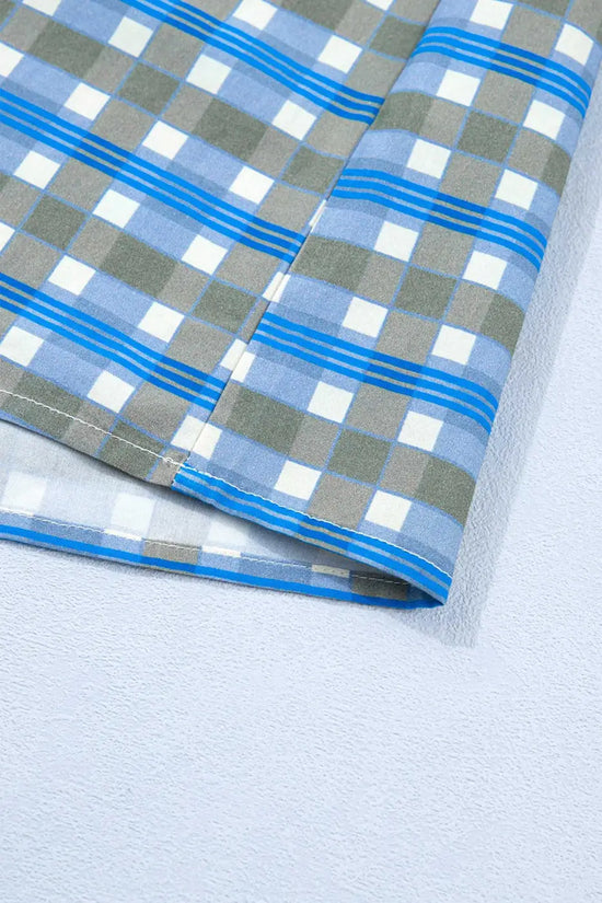 Hem detail of blue plaid long sleeve frilled blouse for women, made of breathable cotton with a relaxed fit and casual spring style.