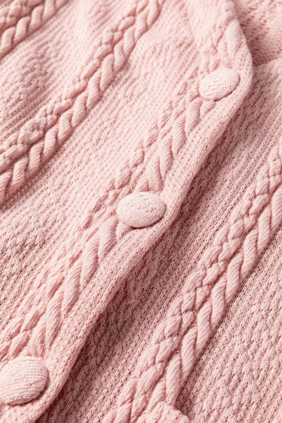 Close-up of the Blush Pink Cable Knit Co‑Ord buttons and textured cable knit fabric, emphasizing the quality and detail of the knitwear.