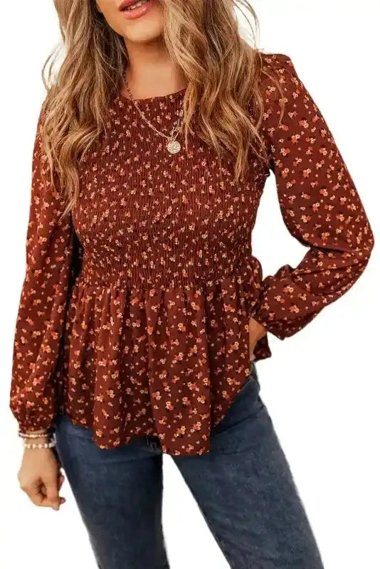 Studio shot of Boho Floral Peplum Blouse on white background, highlighting floral pattern and smocked bodice.