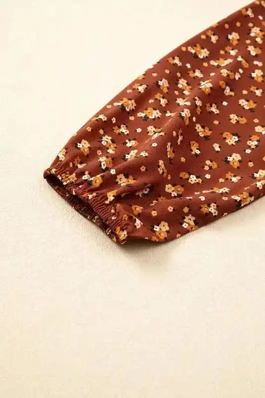 Close-up of Boho Floral Peplum Blouse sleeve with elastic cuff, showing detailed floral print and fabric texture.