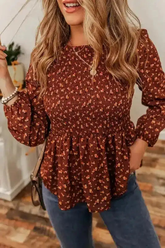 Close-up of Boho Floral Peplum Blouse styled casually, featuring long sleeves and a flattering peplum waist.