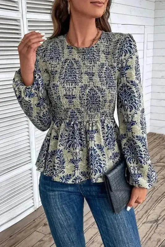 Side view of Floral Smocked Peplum Blouse showing peplum hem flare and gathered balloon sleeve shape — Fashionfitz