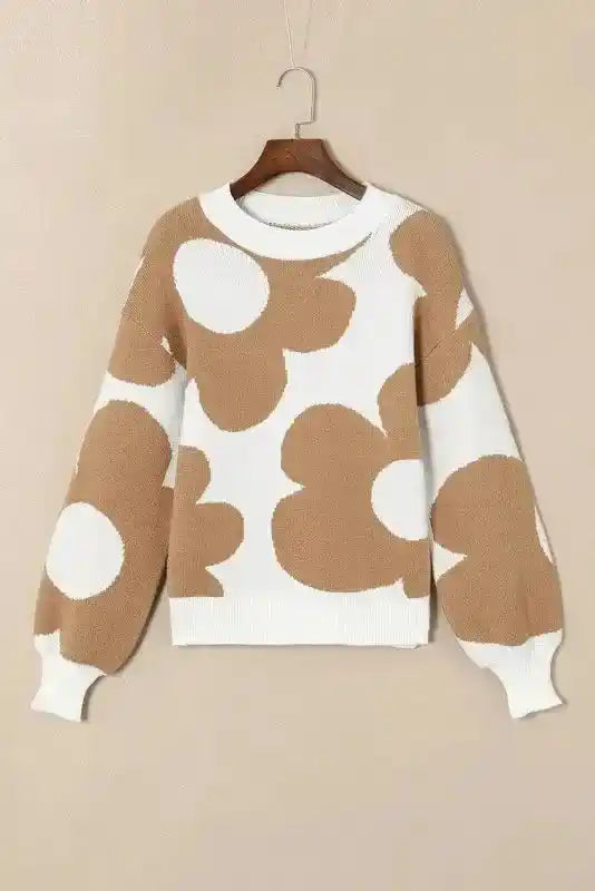 Front view of Bonbon Plus floral sweater on hanger, showcasing beige flower print on white background with ribbed cuffs and hem.