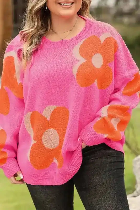 Close-up of Bonbon Plus floral sweater showing vivid pink and orange flower pattern, crafted in soft, high-quality knit.
